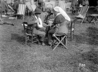 A nurse talks to a wounded soldier during a New Zealand hospital garden party, 24 June 1917