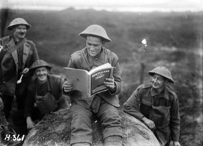 A soldier takes a moment to read ‘New Zealand at the Front’, 20 November 1917