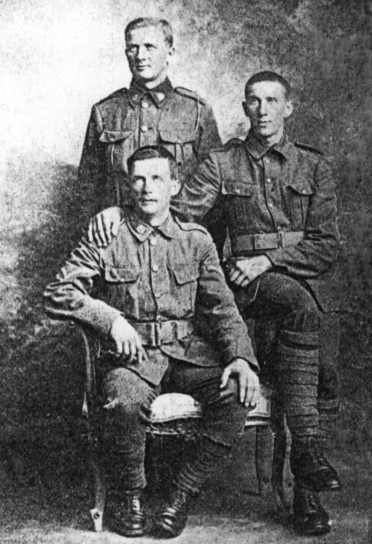 Private James Cairns (standing), Corporal David Cairns (sitting on left) and Private Robert Cairns (sitting on right – served under the alias Thomas Mitchell).